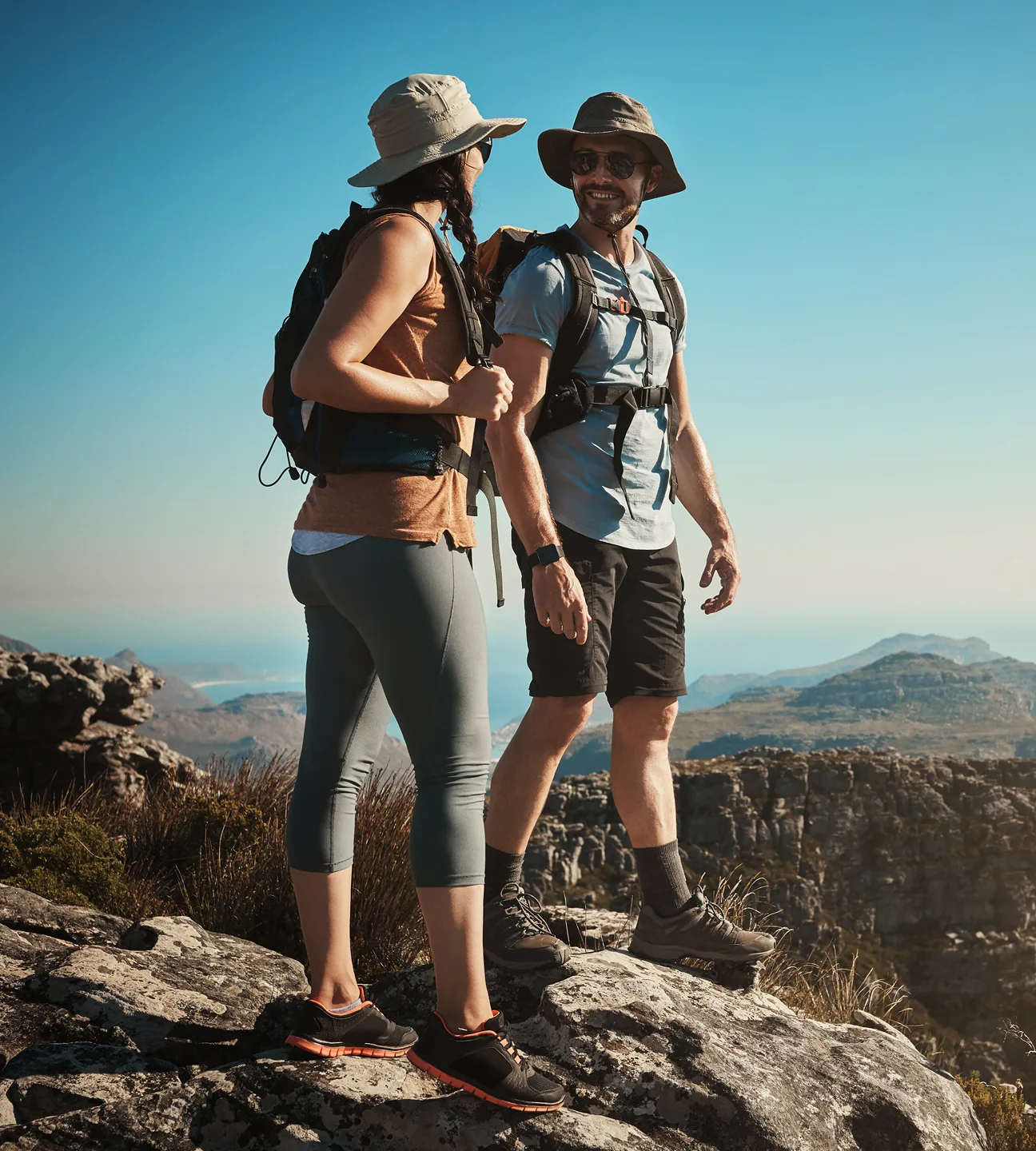 Two travelers overlooking a mountain landscape during a curated experience